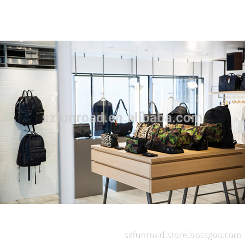 Wooden display cases with glass countertop and wall mounted shelves for bag store decoration